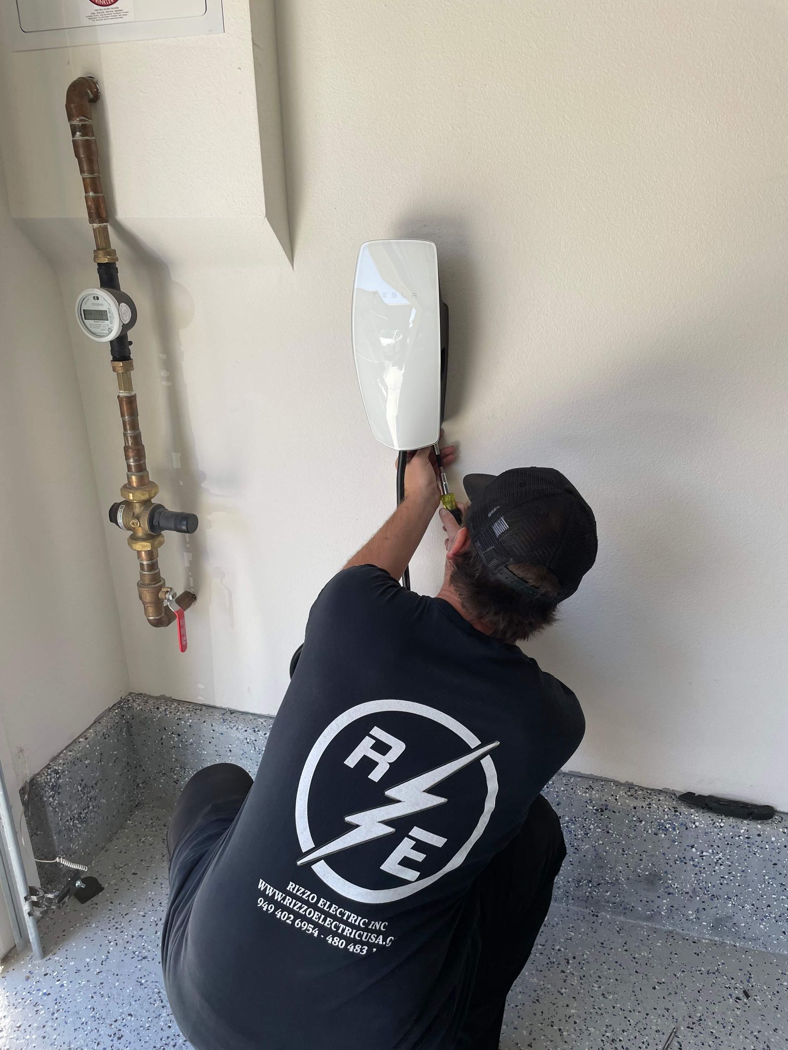 Rizzo Electric crew member installing an EV charger