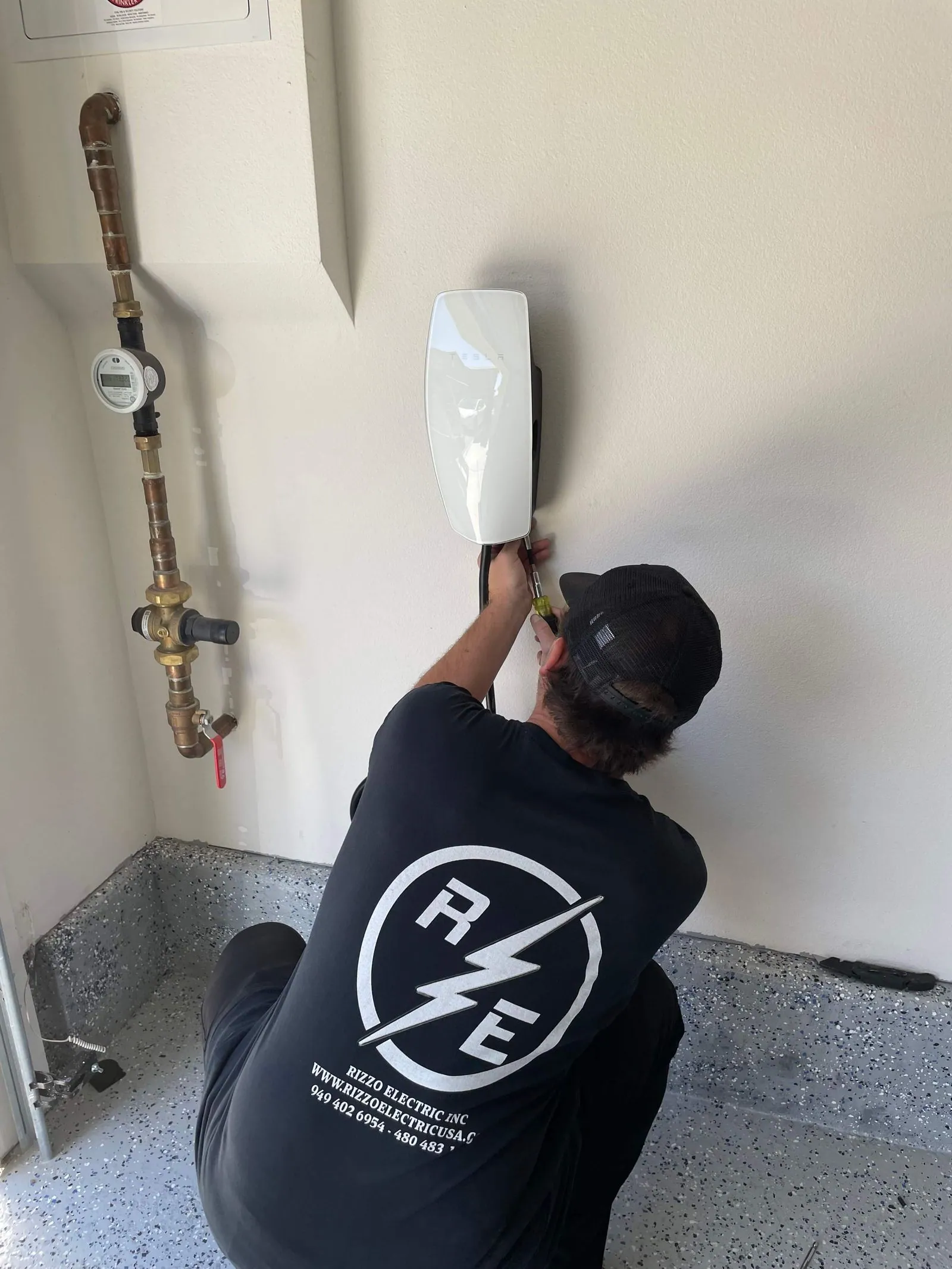 Rizzo Electric owner installing an EV charger at a customer's home